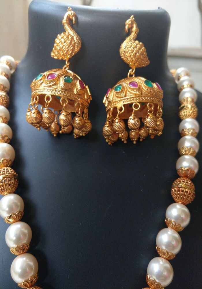 Elegant Dancing Peacock Pendant Temple Jewellery Set from Mugdha Jewellery Store featuring intricate gold-toned peacock pendants adorned with vibrant gemstones and a beaded pearl necklace.