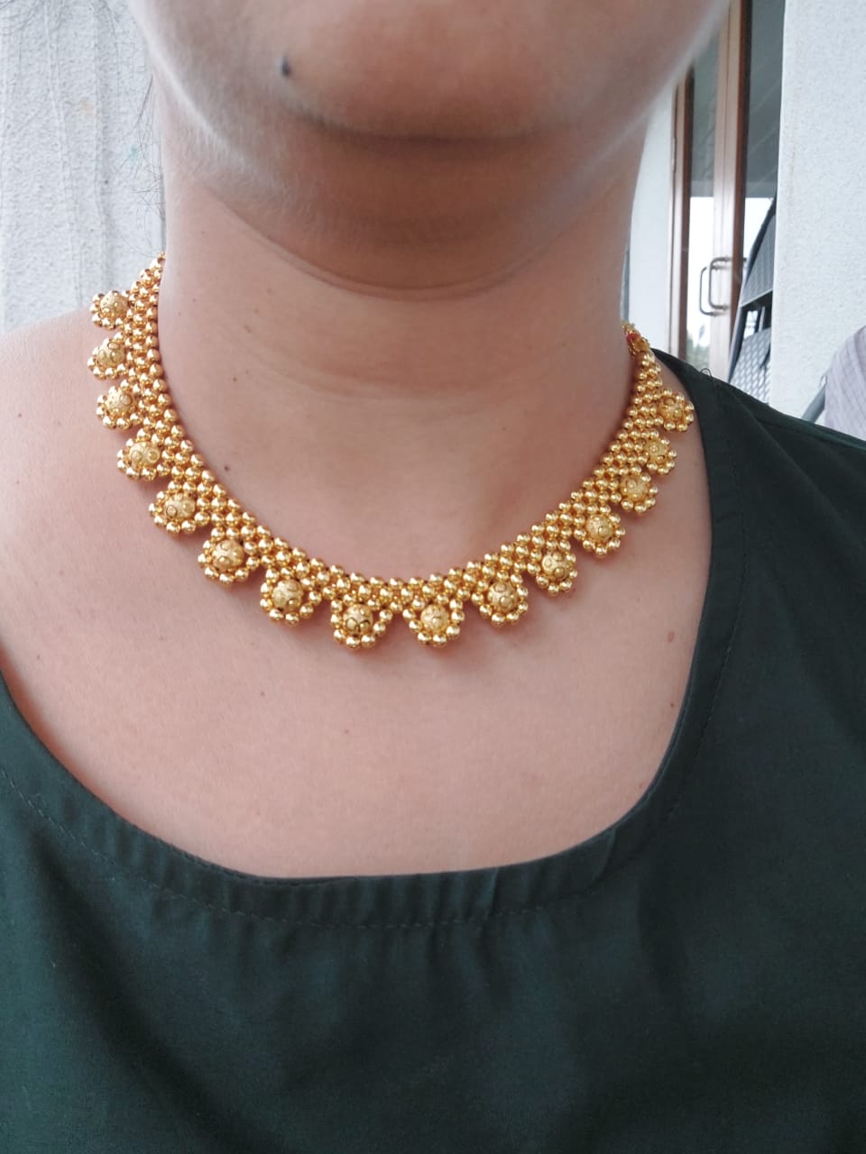 Elegant golden necklace with intricate pearl design, perfect accessory for formal occasions from Mugdha Jewellery Store.