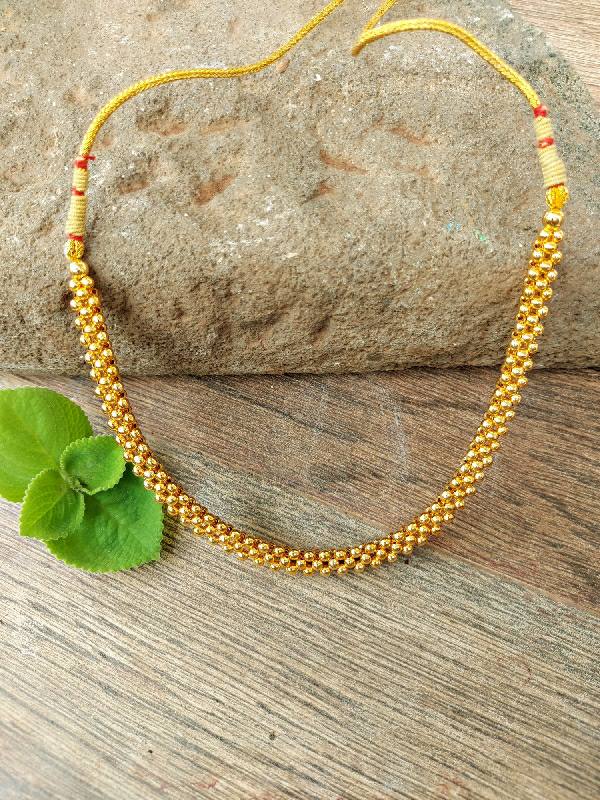 Traditional Single Thushi Gold-Toned Necklace with Red Beads on Wooden Background