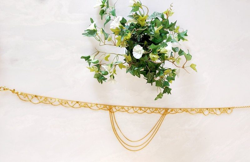 Ornate golden waist belt with floral accents