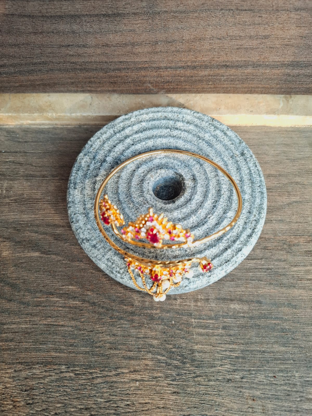 Intricate Felt Spiral Decor - Gray and colorful handcrafted spiral design on rustic wooden surface