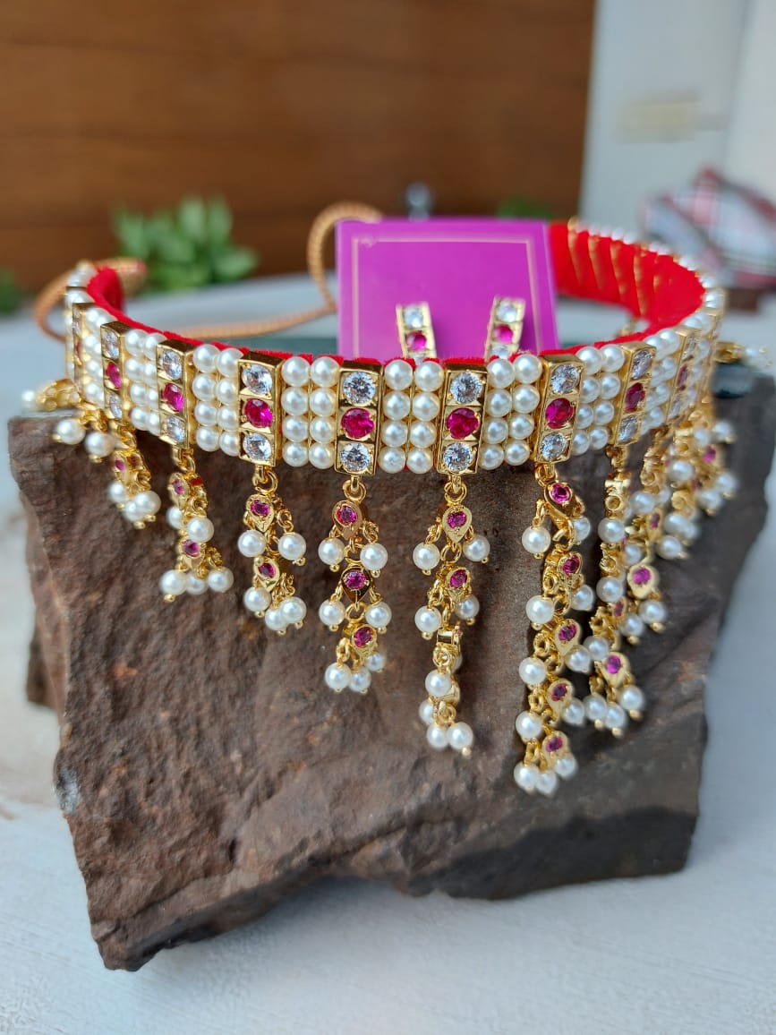 Exquisite Dark Pink White 4 Patti Zhalar Gadi Chinchpeti from Mugdha Jewellery Store, featuring intricate pearl and ruby embellishments on a vibrant purple backdrop.