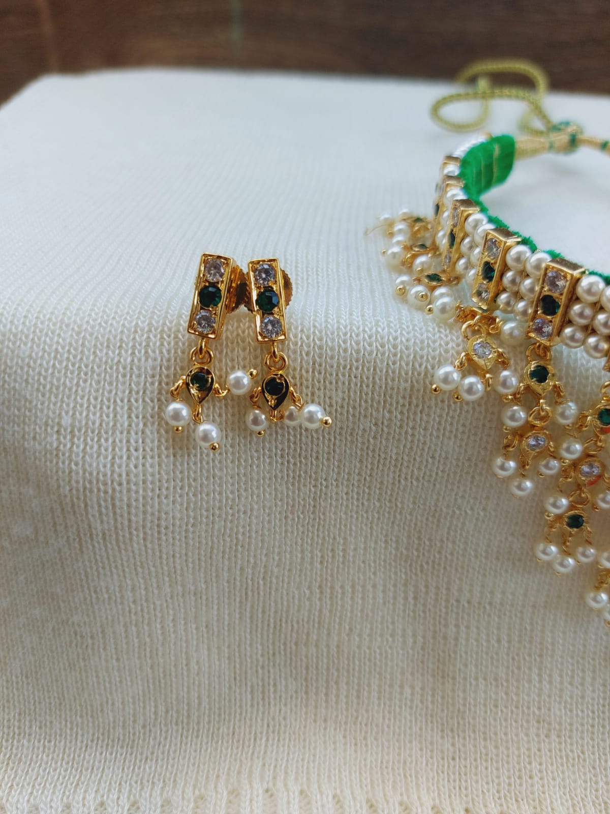 Elegant pearl and emerald studded gold earrings from Mugdha Jewellery Store