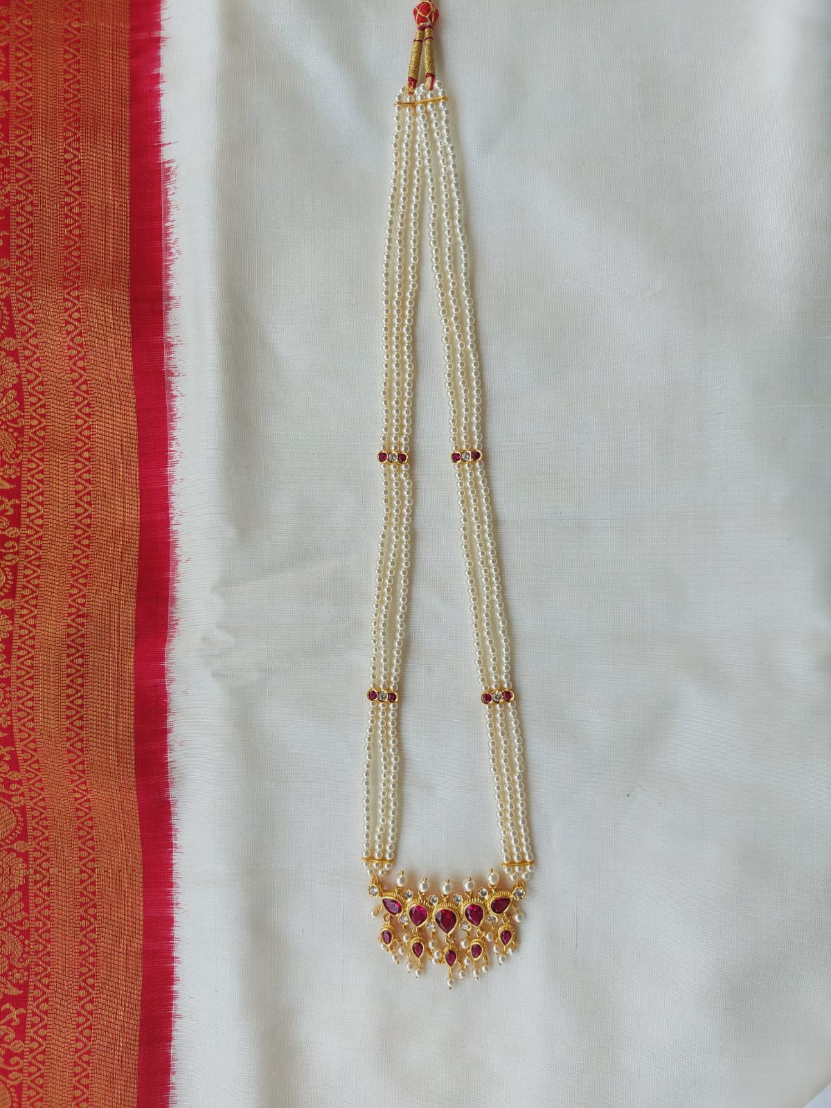 Full Red Long Tanmani 3 Line Haar - Traditional Indian pearl necklace with red beads and golden embellishments.