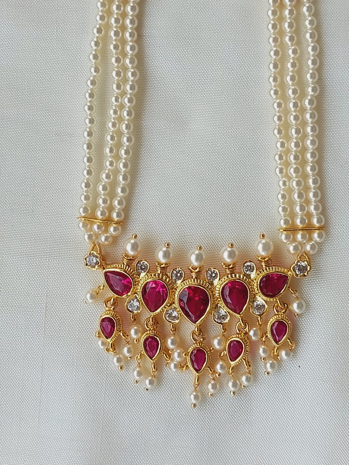 Elegant pearl and ruby necklace with teardrop pendants from Mugdha Jewellery Store