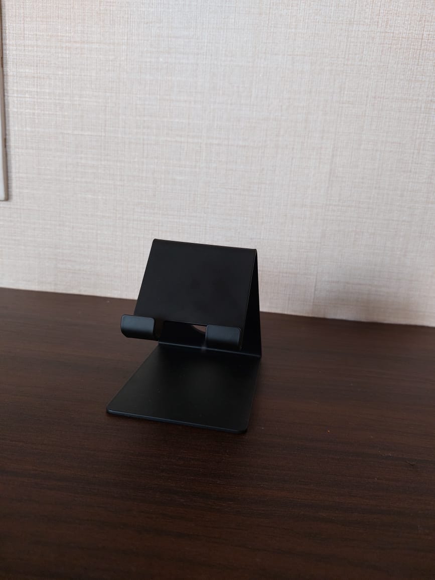 Sturdy black metal mobile phone holder on a wooden desk
