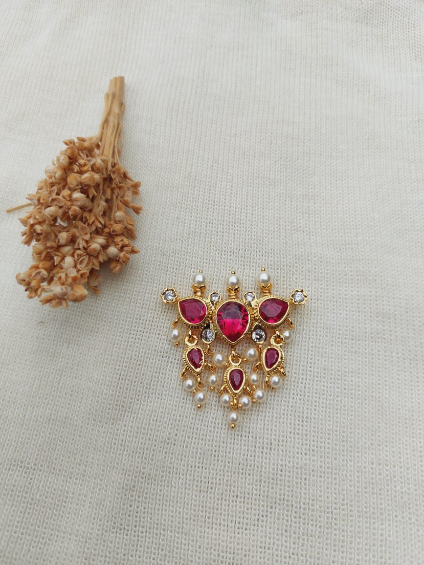 Full Red 3 Stone Puneri Tanmani Pendant - Elegant gold-toned pendant featuring vibrant ruby-colored stones and pearl accents, displayed on a light neutral fabric background.