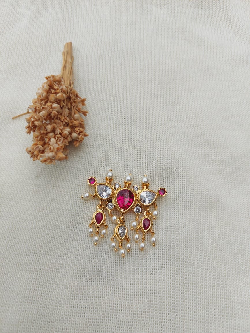 Stunning multicolored gemstone pendant on white textile background