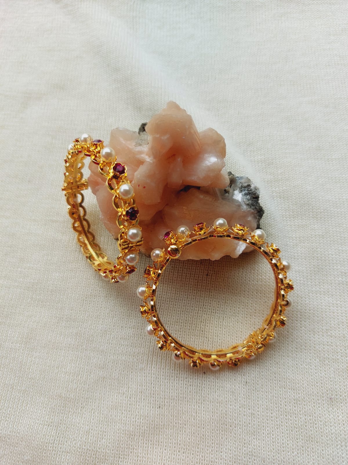 Delicate pearl and gemstone jewelry set on plain background