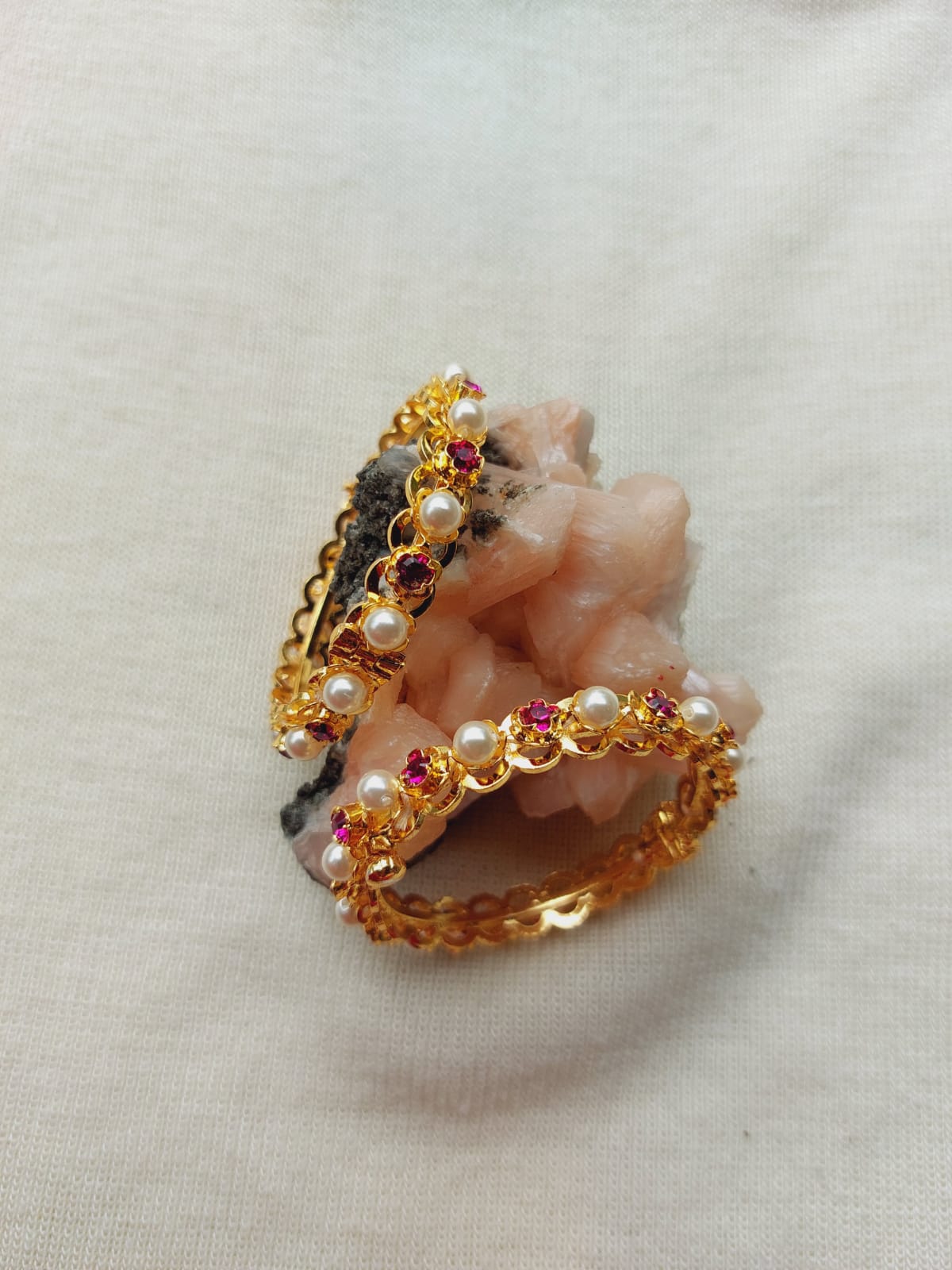 Elegant pearl and gemstone jewelry set against a white background