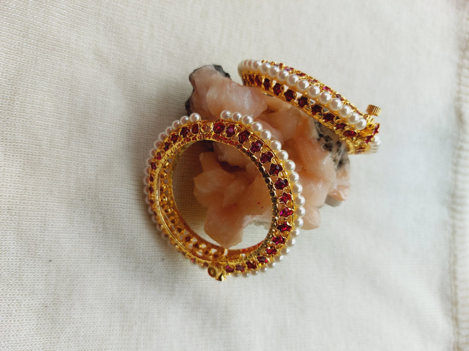 Ornate traditional Moti Tode jewelry for small girls, featuring a central stone surrounded by intricate golden beaded design displayed on a light fabric background.
