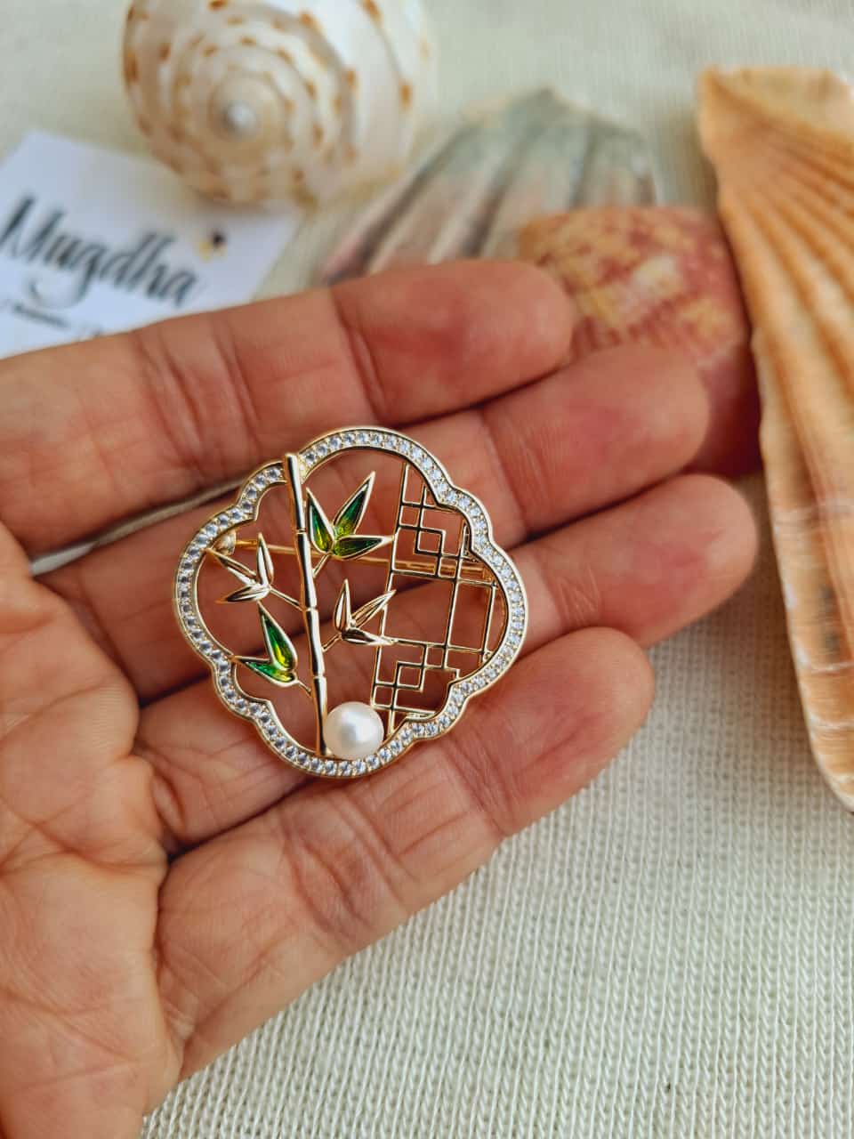 Beautiful nature-inspired bamboo design saree pin cum brooch from Mugdha Jewellery Store, showcasing a delicate floral pattern with intricate details.