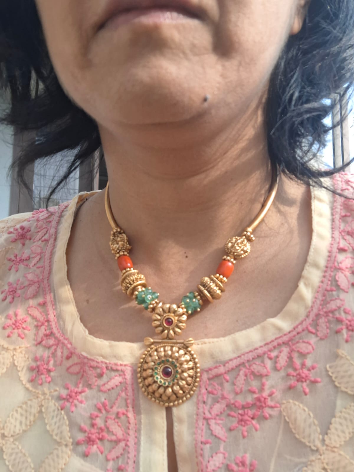 Colorful Designer Necklace with Intricate Floral Pendant
This image shows a beautiful designer necklace featuring a vibrant assortment of beads and a central floral pendant. The necklace appears to be made of gold-toned metal and includes red, green, and blue accents, creating a visually striking and intricate piece of jewelry.