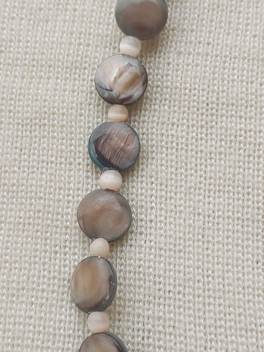Elegant nature-inspired necklace with real seashell beads on neutral background