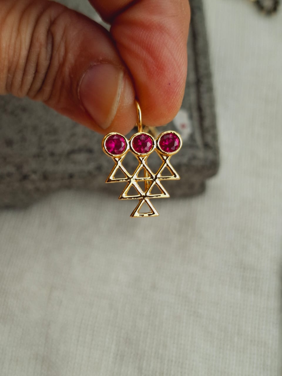 Elegant ruby and gold triangle-shaped pendant from Mugdha Jewellery Store