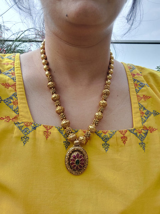 Lavanya Designer Beads Flower Pendant Necklace from Mugdha Jewellery Store
Gold-toned beaded necklace with ornate floral pendant showcasing intricate design