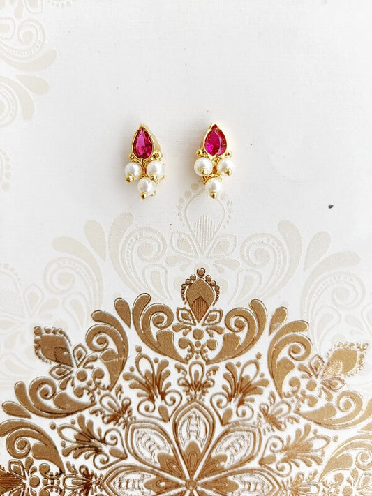 Elegant pink stone karwari draksha small earrings on a decorative white background
